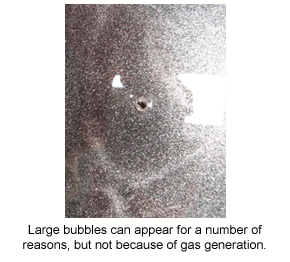 A bubble like this in an epoxy film isn't caused by out-gassing.