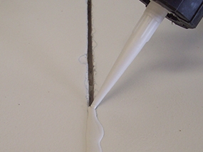 A sealant being used to seal a concrete joint.